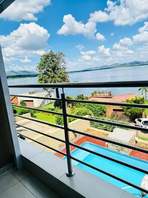 a balcony with a view of the water at The Holiday House Harties in Hartbeespoort