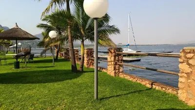 a street light in the grass next to the water at The Holiday House Harties in Hartbeespoort