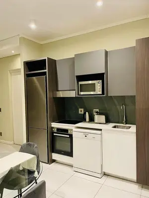 a kitchen with stainless steel appliances and a microwave at The Comfort AirB&B - On the 8th floor luxury 1 bedroom apartment with views in Pretoria