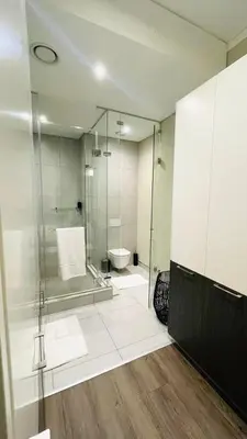 a bathroom with a glass shower and a toilet at The Comfort AirB&B - On the 8th floor luxury 1 bedroom apartment with views in Pretoria