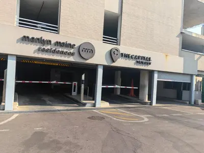 a parking lot in front of a building at The Comfort AirB&B - On the 8th floor luxury 1 bedroom apartment with views in Pretoria