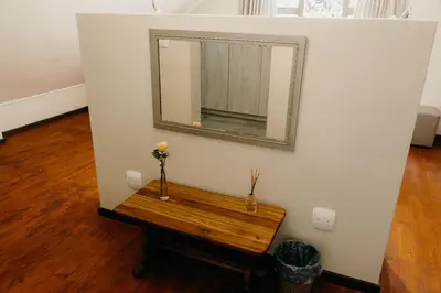 a mirror on a wall with a wooden table at Ruzelle Family House in Hazyview