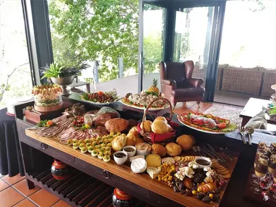 a table filled with lots of different types of food at Greenfire Game Lodge in Balule Game Reserve