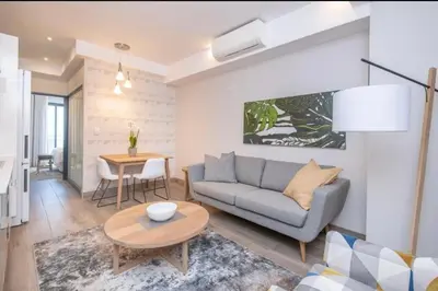 a living room with a couch and a table at The Regency Cosy Apartment- 419 in Pretoria