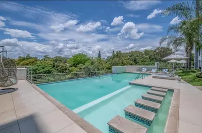 a swimming pool with a view of a resort at The Regency Cosy Apartment- 419 in Pretoria