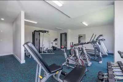 a gym with several treadmills and cardio machines at The Regency Cosy Apartment- 419 in Pretoria