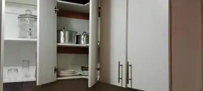 a kitchen with white cabinets and utensils at Botanik in Pretoria