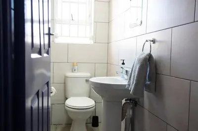 a small bathroom with a toilet and a sink at The Plum in Louis Trichardt