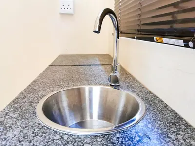 a stainless steel sink in a kitchen counter at Genesis Guesthouze in Bela-Bela