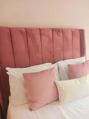 a bunch of pillows sitting on top of a bed at Genesis Guesthouze in Bela-Bela