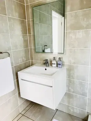 a bathroom with a white sink and a mirror at The Blyde in Pretoria
