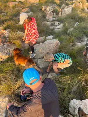 a man and two children and a dog and a girl at Kwaggaskop Farm Stoephuis in Dullstroom