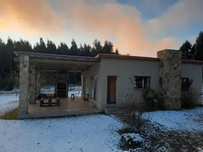a building with snow on the ground in front of it at Kwaggaskop Farm Stoephuis in Dullstroom