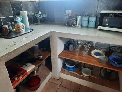 a kitchen with a counter top with a microwave at Kwaggaskop Farm Stoephuis in Dullstroom