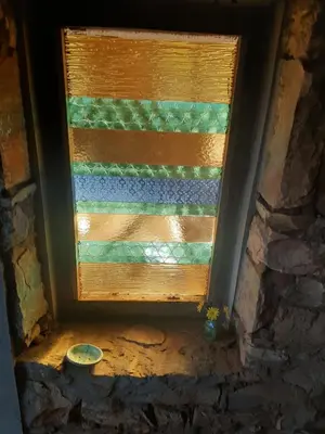 a window in a room with a stone wall at Kwaggaskop Farm Kliphuis in Dullstroom