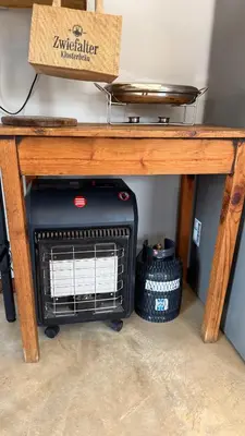 a heater under a table with a box on top at Dullstroom Self Catering Blue Crane Estate 66 in Dullstroom