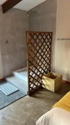 a room with a bed and a wooden door at Dullstroom Self Catering Blue Crane Estate 66 in Dullstroom