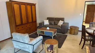a living room with a couch and a chair at Dullstroom Self Catering Blue Crane Estate 66 in Dullstroom