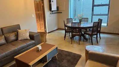 a living room with a couch and a table at Dullstroom Self Catering Blue Crane Estate 66 in Dullstroom