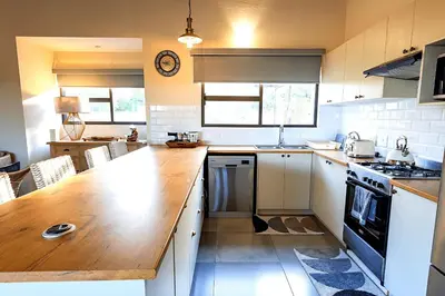 a kitchen with a wooden counter top in a room at Ndlovu Bushvilla at Elephant Rock Eco Estate in Mica
