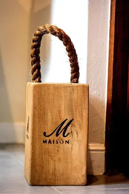 a wooden bag with a handle sitting on the floor at Ndlovu Bushvilla at Elephant Rock Eco Estate in Mica