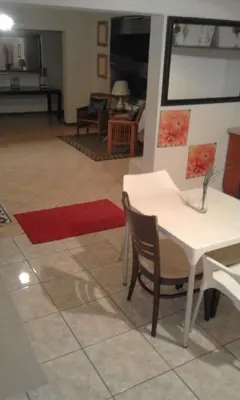 a living room with a white table and chairs at Bushbuckridge Micanolia Guest House in Dwarsloop