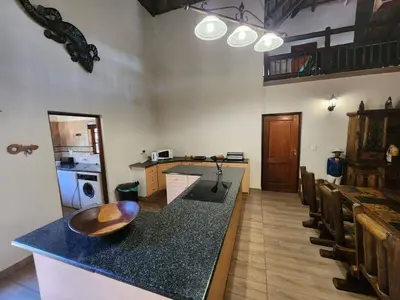a kitchen with a counter with a wooden bowl on it at Bateleur Lodge, Mabalingwe in Bela-Bela