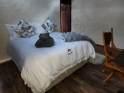 a white bed with towels on top of it at Boomhuis, Mabalingwe Nature Reserve in Bela-Bela
