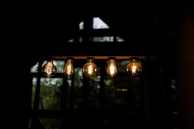 a chandelier in a dark room with a window at Boomhuis, Mabalingwe Nature Reserve in Bela-Bela