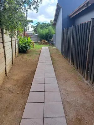 a pathway in a yard next to a fence at Partridge Place in Kempton Park