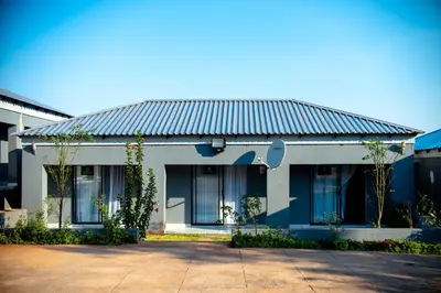 a house with a tin roof on a street at Lugogo Guesthouse in Thohoyandou