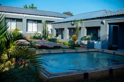 a swimming pool in front of a house at Lugogo Guesthouse in Thohoyandou
