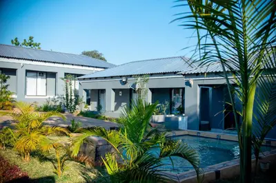 a house with a swimming pool in front of it at Lugogo Guesthouse in Thohoyandou
