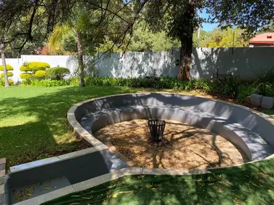 a small fire pit in a yard in a backyard at Bridgelamour Accommodation in Hartbeespoort