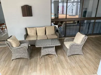 a living room with a couch and two chairs at Bridgelamour Accommodation in Hartbeespoort