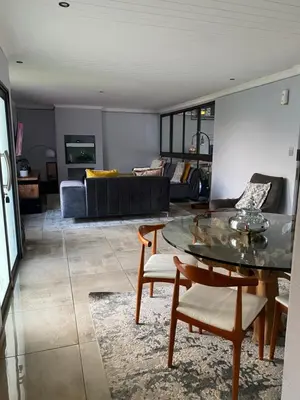 a living room with a table and a couch at Bridgelamour Accommodation in Hartbeespoort