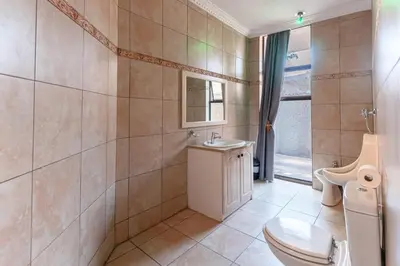 a bathroom with a toilet and a sink at Villa Africa Boutique Hotel & Spa in Pretoria