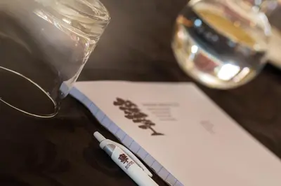 a pen sitting on a table next to a glass at Bluegum Country Lodge in Bethal