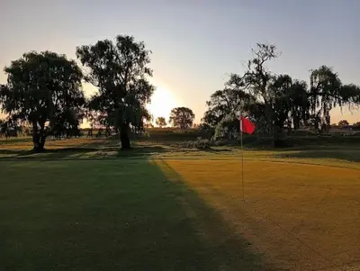 a red flag in the middle of a golf course at Bluegum Country Lodge in Bethal
