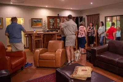 a group of people standing in a living room at Bluegum Country Lodge in Bethal