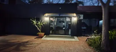 a front door of a house with a potted plant at Waterfront Guest House in Hartbeespoort