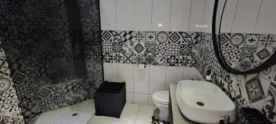 a bathroom with a sink and a toilet at Waterfront Guest House in Hartbeespoort