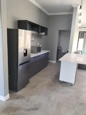 a kitchen with a refrigerator and a counter in it at Sango on 9 in Naboomspruit