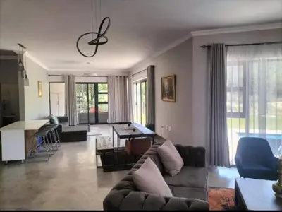 a living room with a couch and a table at Sango on 9 in Naboomspruit