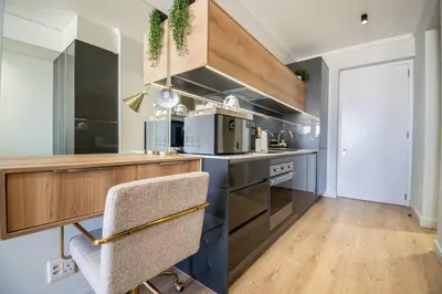 a kitchen with a counter and a chair in it at Beautiful Gem at Ellipse in Midrand