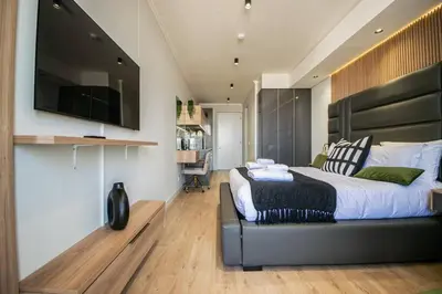 a bedroom with a large bed and a television at Beautiful Gem at Ellipse in Midrand