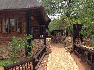 a small house with a fence and a stone walkway to it at Adansonia Eco Lodge in Musina