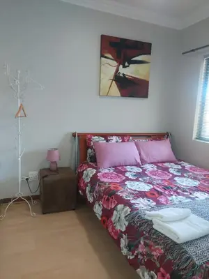 a bedroom with a bed and a painting on the wall at Premium Getaway @ la Bella Costa in Pretoria