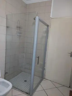 a shower with a glass door in a bathroom at Premium Getaway @ la Bella Costa in Pretoria