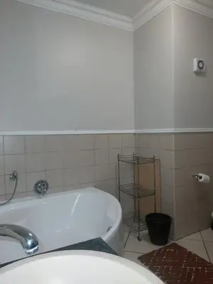 a bathroom with a tub and a sink at Premium Getaway @ la Bella Costa in Pretoria